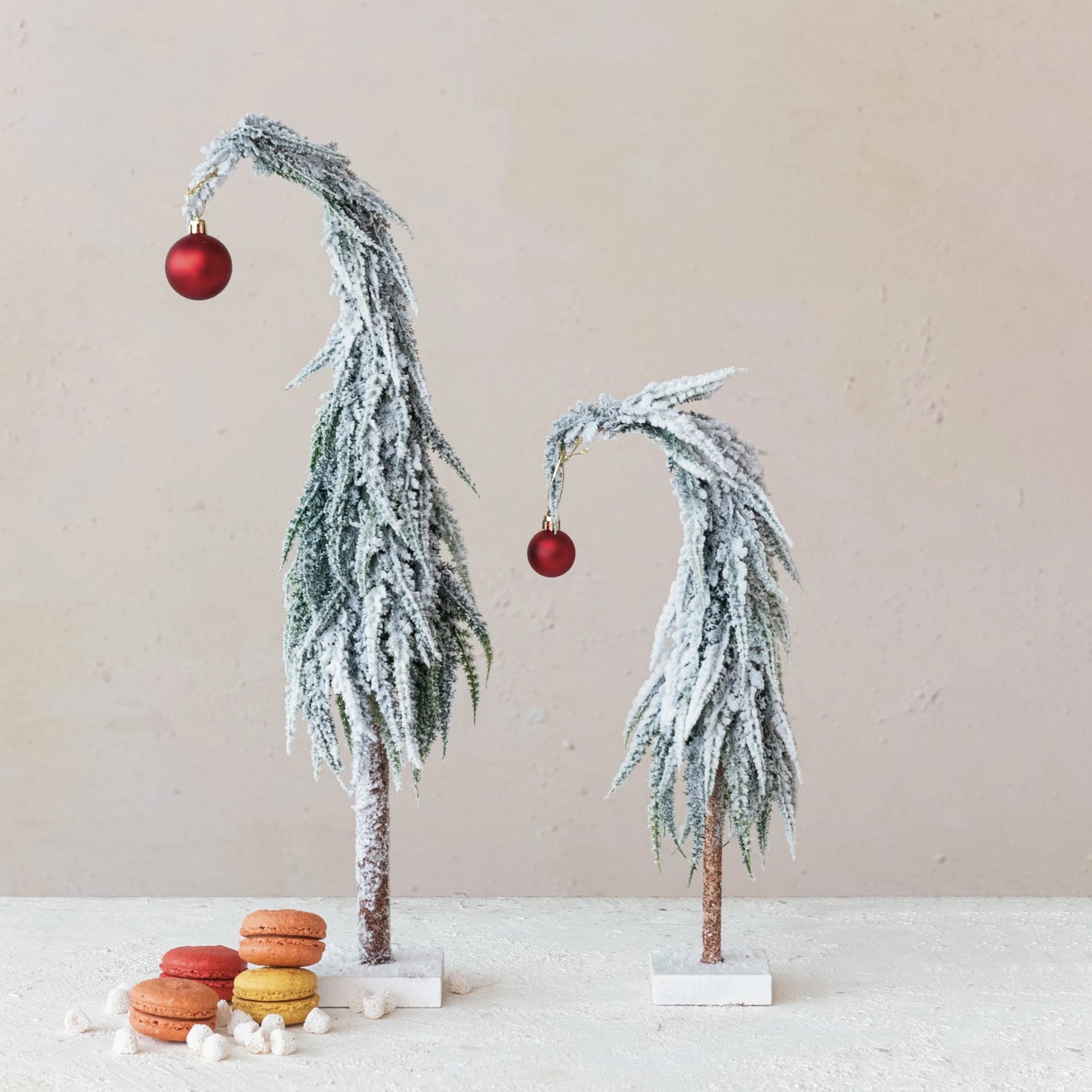 Small Leaning Evergreen Tree With Red Ball Ornament